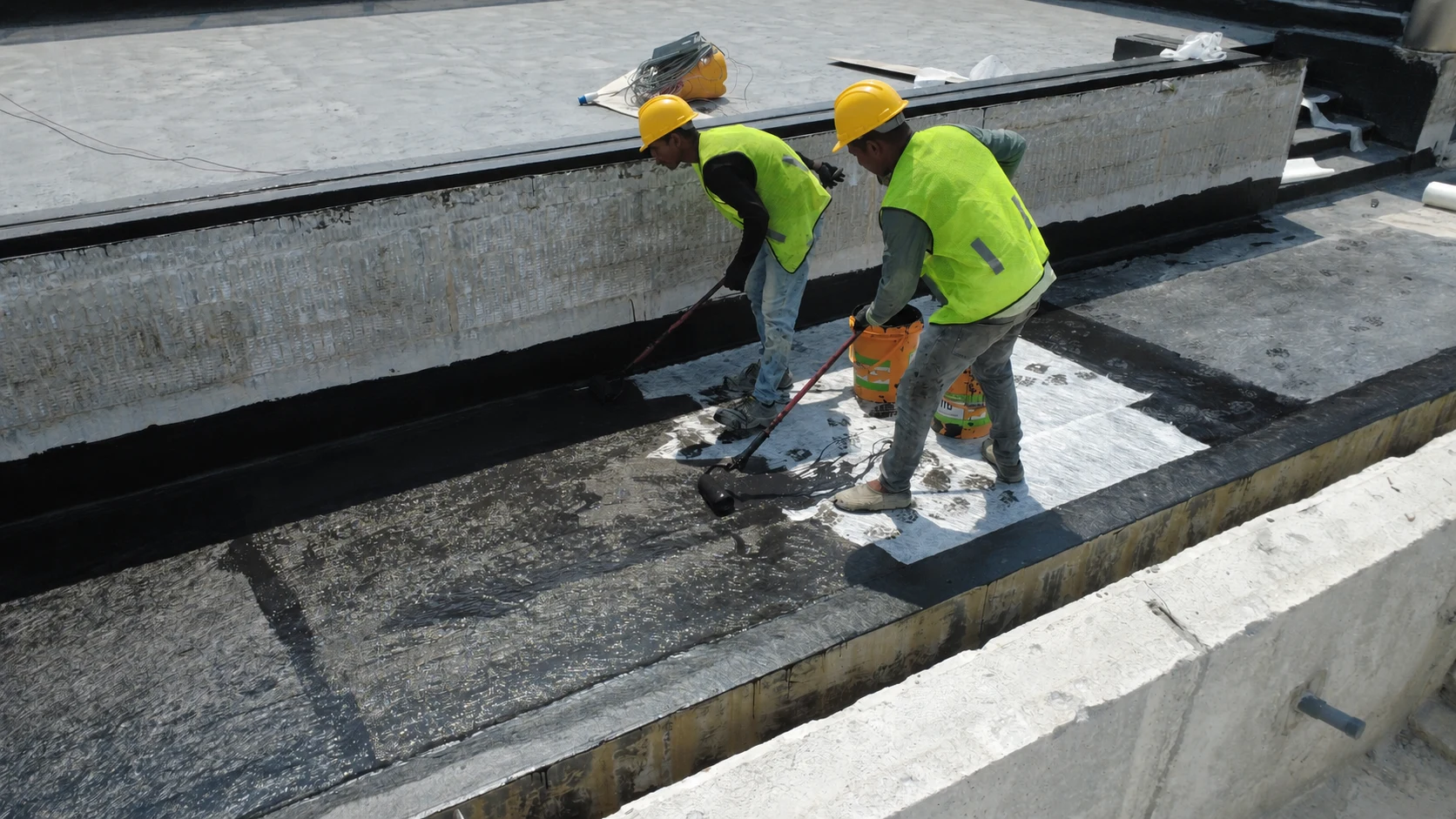 Waterproofing materials being applied